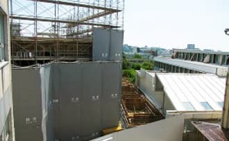 新校舎棟の上に設置された校章の写真